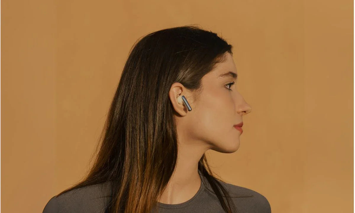 Wireless earbud in woman's ear, sleek design for immersive Bluetooth audio experience
