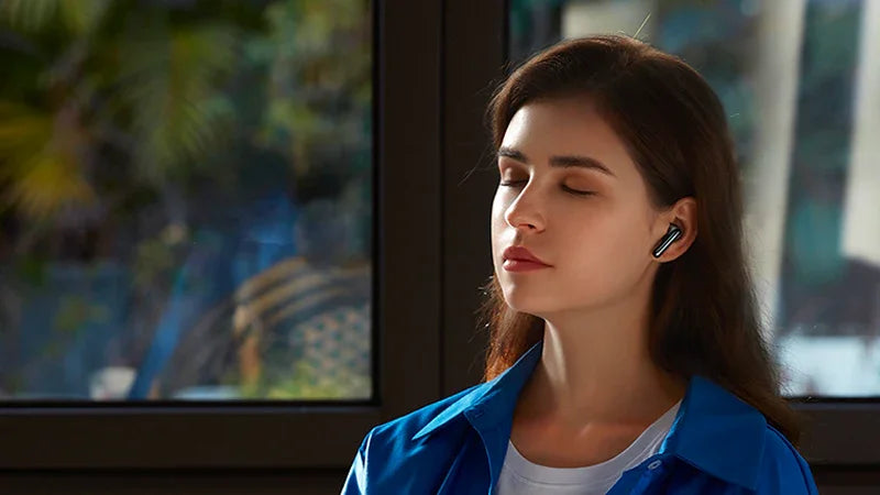 Woman enjoying immersive sound with wireless earbuds, perfect for iOS & Android