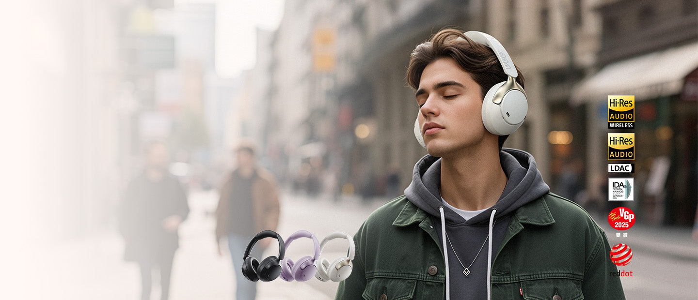 Young man wearing white wireless over-ear headphones on city street. Black, purple, and white color options shown with Hi-Res
