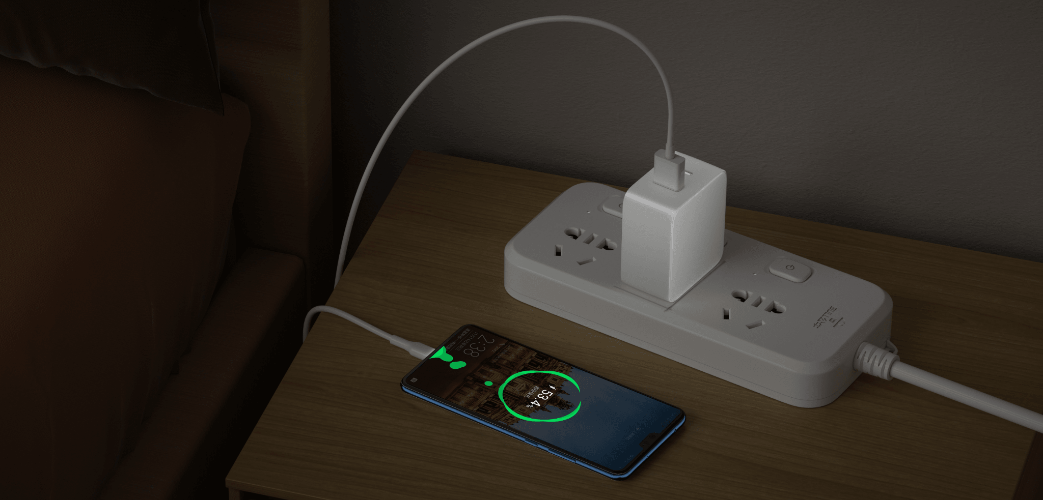 Smartphone charging overnight on bedside table with power strip and wall adapter