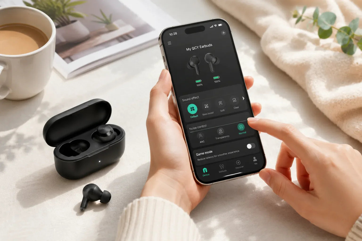 Person using the QCY app on a smartphone to customize sound and noise control settings for QCY wireless earbuds.