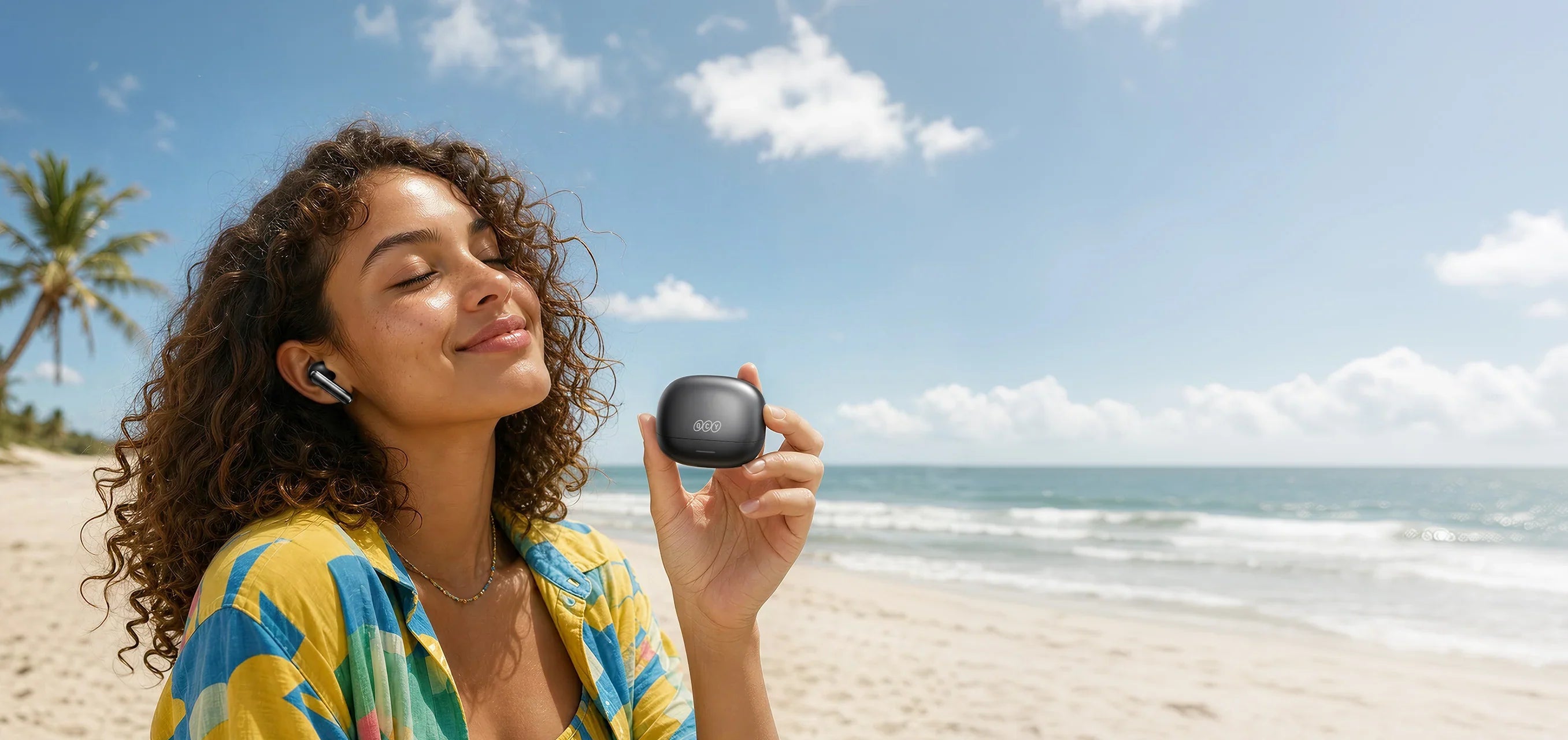 Woman on beach using QCY wireless earbuds with low latency mode for seamless audio.