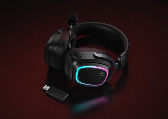 Black gaming headset with RGB lighting and USB receiver on dark wood background.