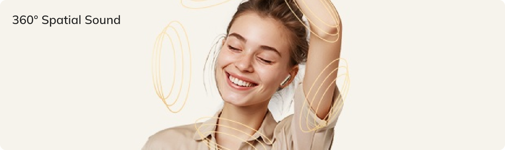 Woman enjoying 360° spatial sound with wireless earbuds, smiling and raising hand.